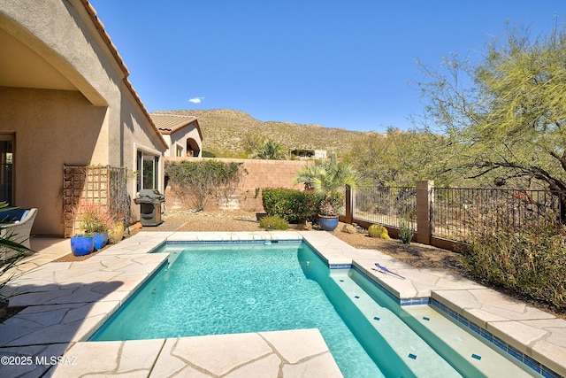 view of swimming pool with a fenced backyard, a grill, a patio, and a mountain view