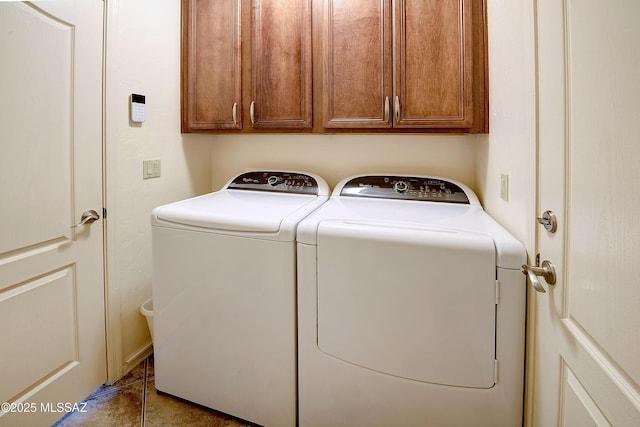 washroom with cabinet space and washing machine and clothes dryer