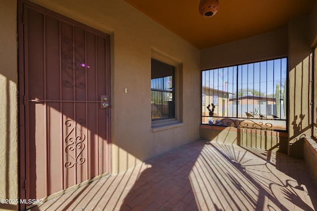 exterior space featuring stucco siding and a balcony