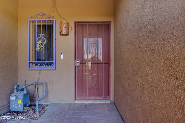 property entrance with stucco siding