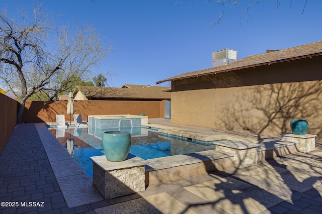 view of pool with a fenced in pool, an in ground hot tub, a fenced backyard, and a patio area