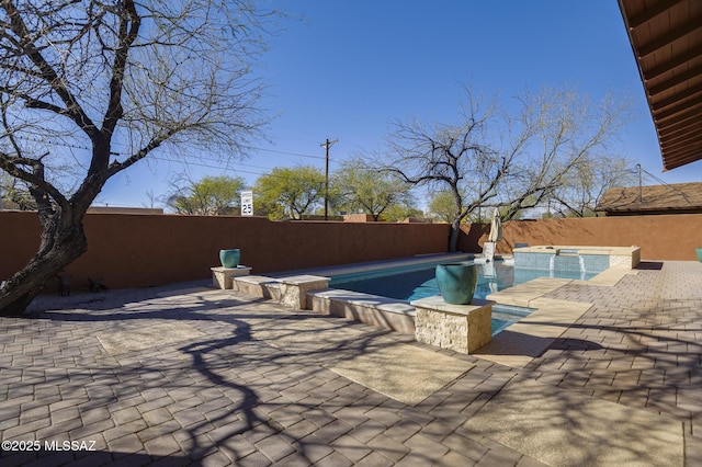 view of swimming pool featuring a fenced in pool, an in ground hot tub, a fenced backyard, and a patio area