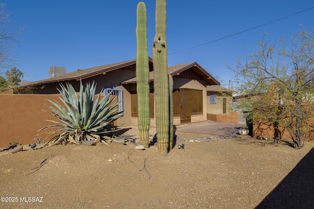 exterior space featuring a patio area and stucco siding