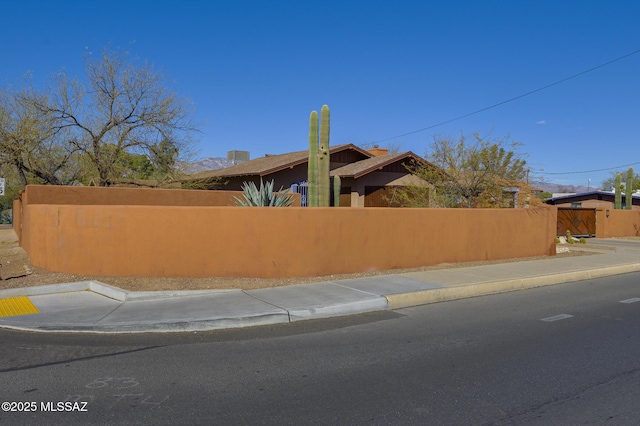 view of property exterior featuring a fenced front yard and stucco siding