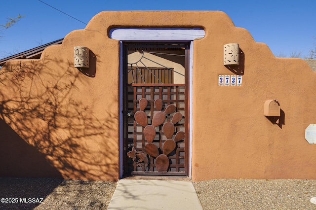 property entrance with stucco siding