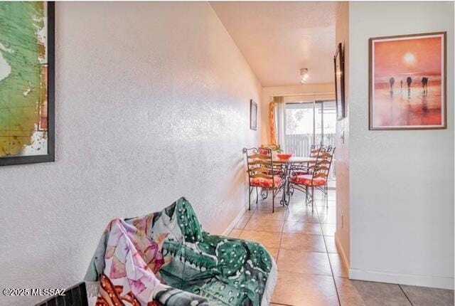 35 E Pastime Rd, Tucson, AZ 85705 - hall with light tile patterned floors, a textured wall, and baseboards