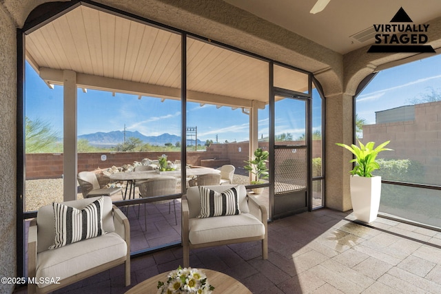 sunroom featuring a mountain view