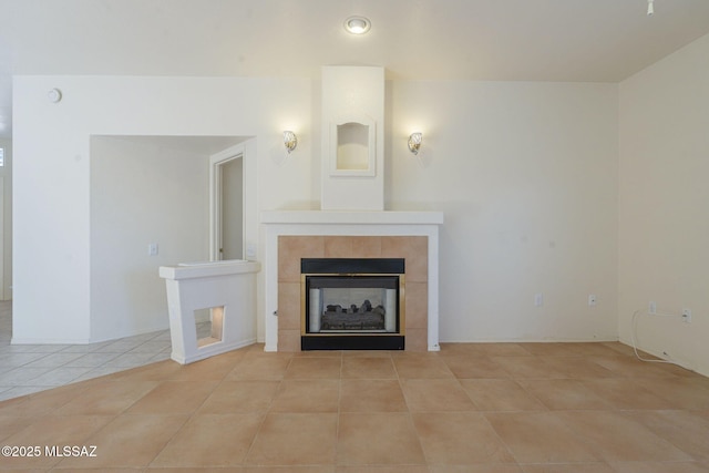 unfurnished living room featuring a tiled fireplace and light tile patterned flooring