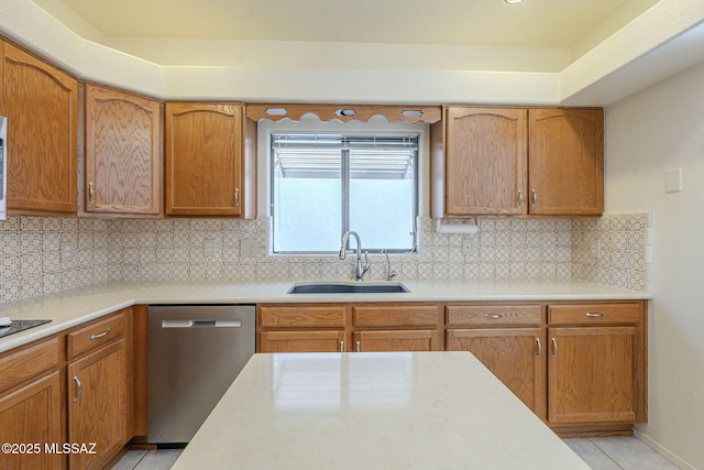 kitchen with light countertops, a sink, and stainless steel dishwasher