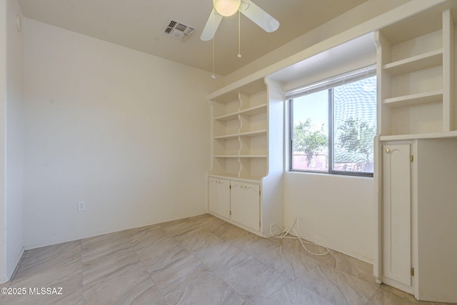 unfurnished room featuring visible vents and ceiling fan