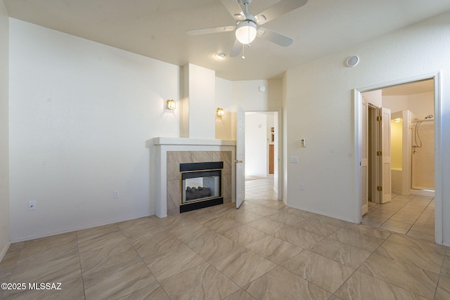 unfurnished living room with a ceiling fan and a fireplace