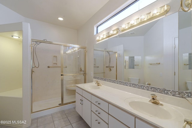 bathroom with a stall shower, a sink, and toilet