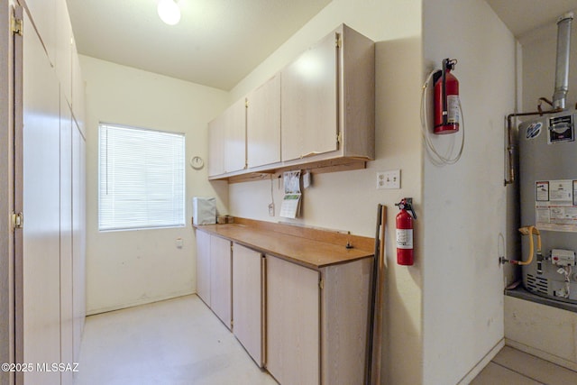 kitchen featuring light countertops and water heater