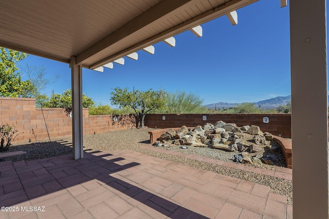 view of patio featuring a fenced backyard and a mountain view