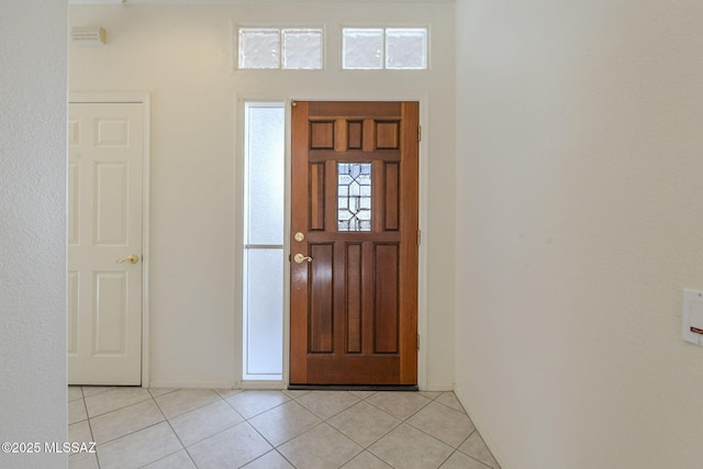 entryway featuring light tile patterned flooring and baseboards