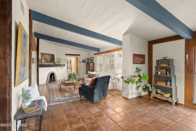 living area with wooden ceiling, visible vents, a fireplace, and lofted ceiling with beams