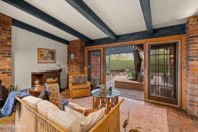 living area featuring brick floor, brick wall, and beamed ceiling