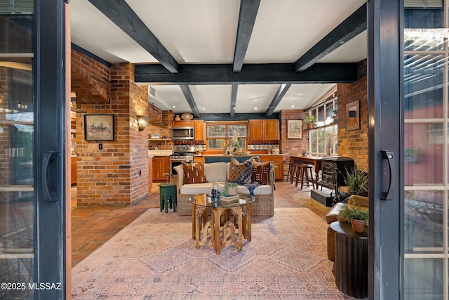 living room featuring brick floor, brick wall, and beamed ceiling