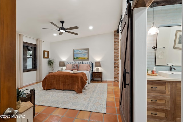 tiled bedroom featuring ceiling fan, connected bathroom, a sink, and recessed lighting