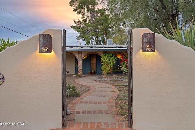 southwest-style home featuring central AC unit and stucco siding