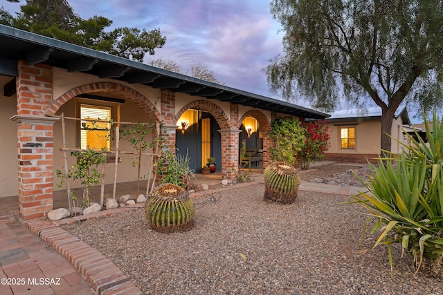 view of front of property featuring a porch and brick siding