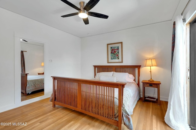 bedroom featuring a ceiling fan and wood finished floors