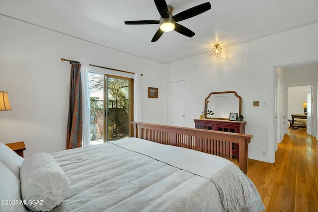 bedroom with a ceiling fan, light wood-style flooring, and access to exterior