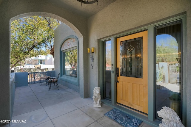 doorway to property featuring stucco siding