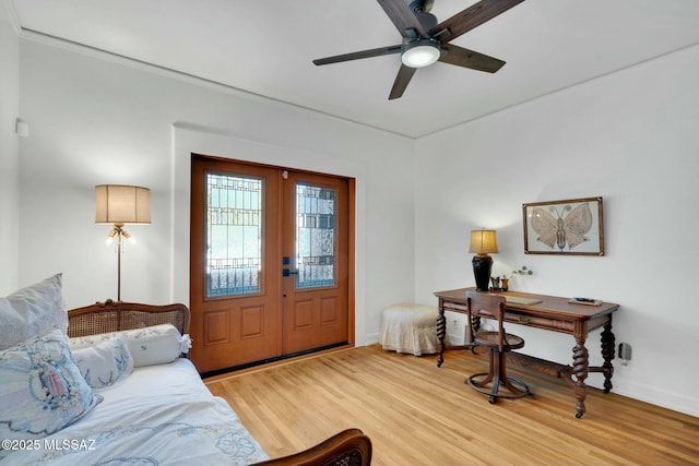 interior space featuring ceiling fan, baseboards, wood finished floors, and french doors