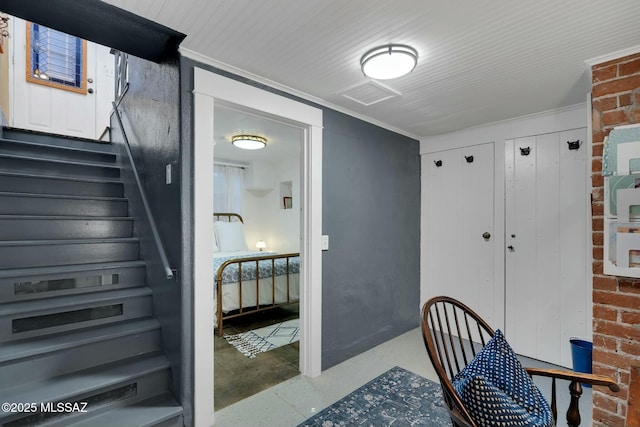 interior space with visible vents, stairs, and ornamental molding