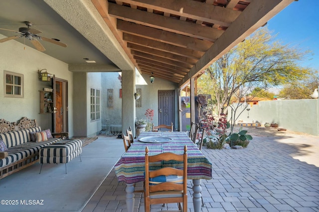 view of patio featuring ceiling fan and fence