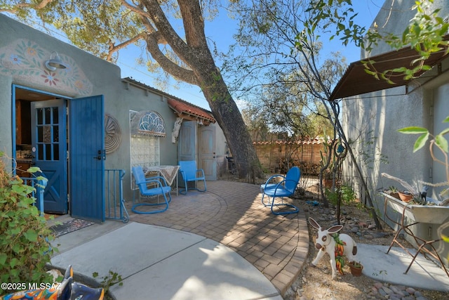 view of patio featuring fence