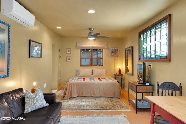 bedroom with recessed lighting, a wall unit AC, and baseboards