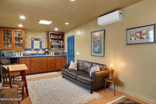 living area with recessed lighting, baseboards, and a wall mounted AC