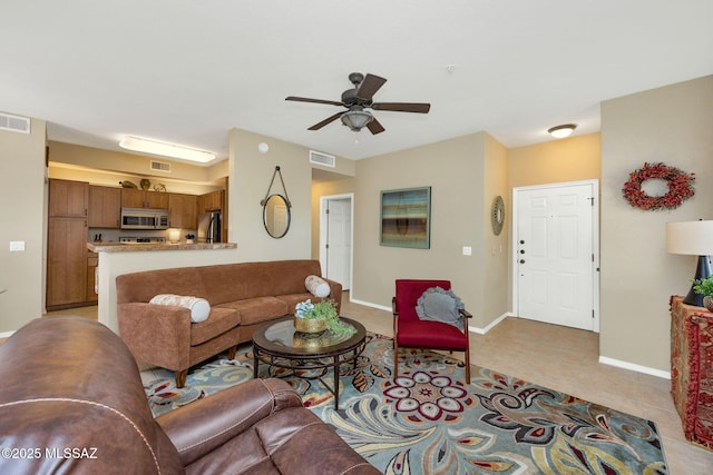 living area featuring visible vents, baseboards, and light tile patterned flooring