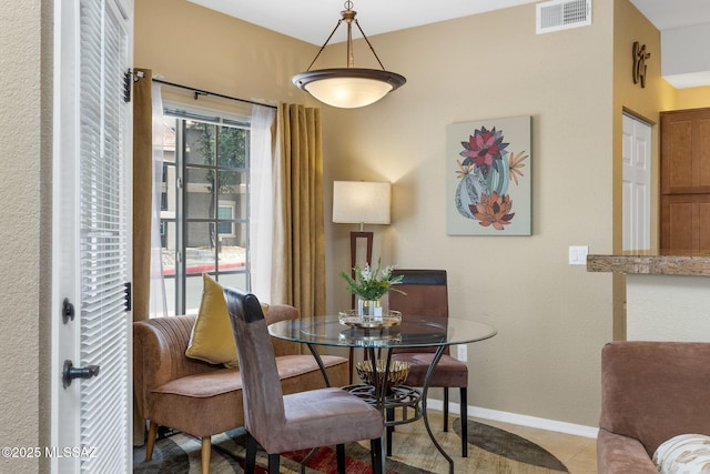 dining area featuring visible vents, baseboards, and light tile patterned flooring