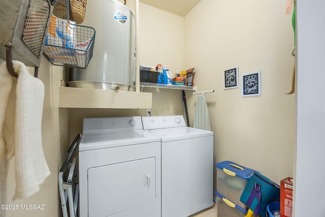 laundry room featuring laundry area, water heater, and washing machine and clothes dryer