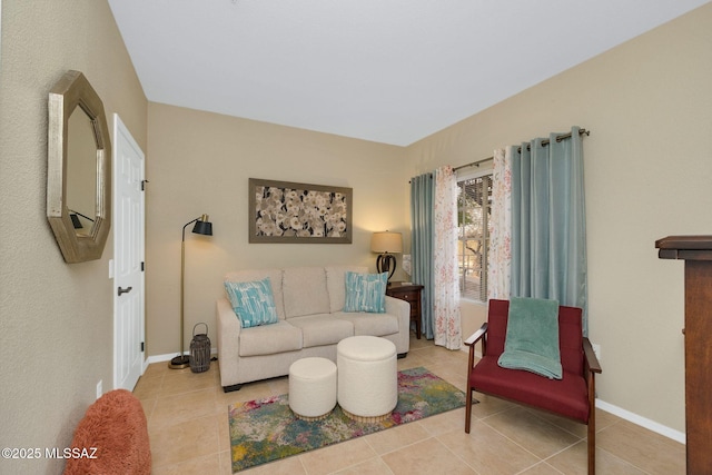 living area featuring tile patterned flooring and baseboards