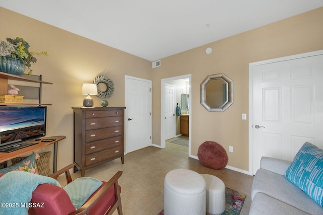 tiled living area featuring visible vents and baseboards