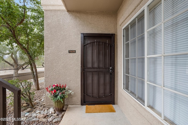 property entrance featuring stucco siding