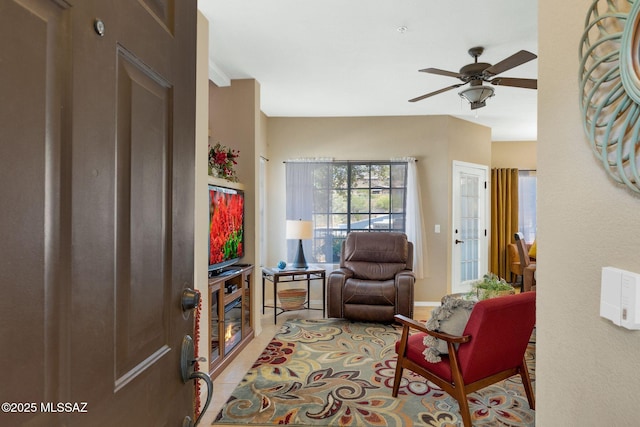 interior space with light tile patterned floors and a ceiling fan