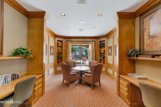 dining space featuring ornamental molding, built in study area, visible vents, and built in features