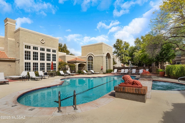 pool featuring fence and a patio