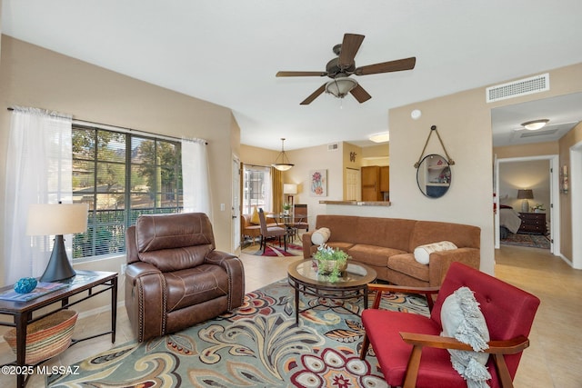 tiled living area with ceiling fan and visible vents