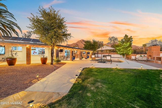 surrounding community featuring a lawn and a patio area