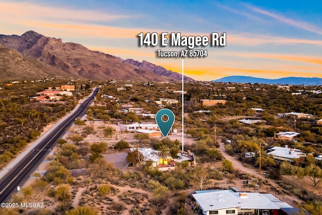 aerial view at dusk featuring a mountain view