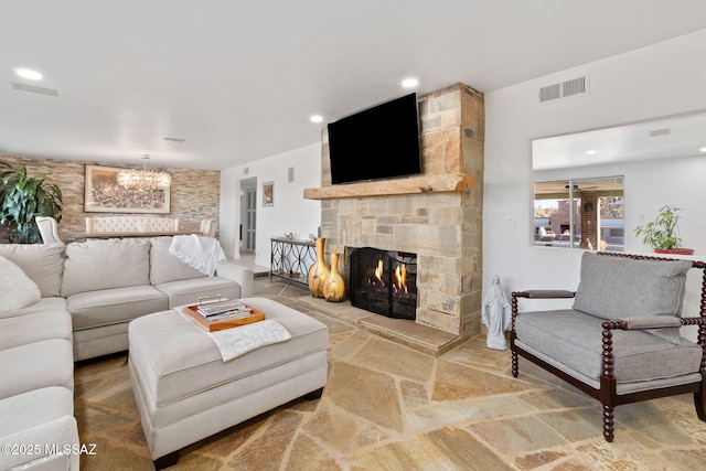 living room featuring an inviting chandelier, a fireplace, visible vents, and recessed lighting