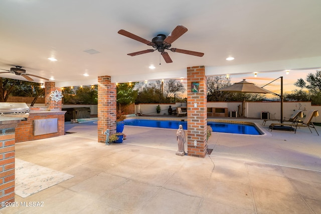 view of pool featuring area for grilling, a fenced backyard, ceiling fan, exterior kitchen, and a patio area