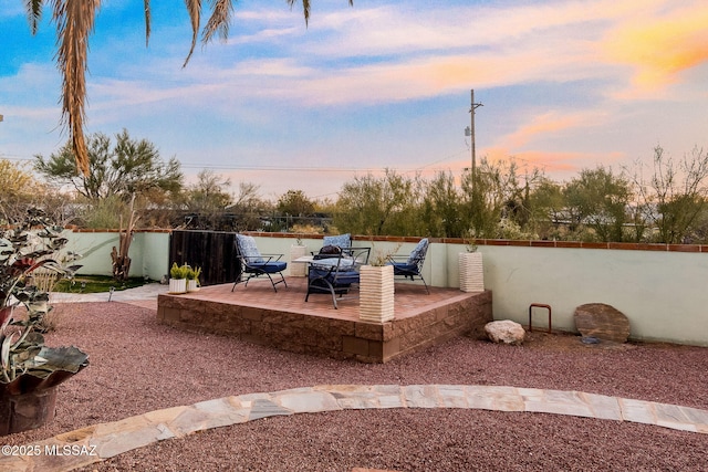 yard at dusk with fence and a patio