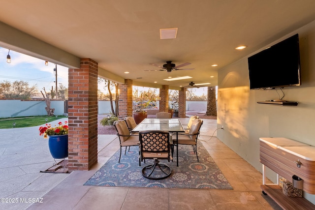 view of patio featuring outdoor dining area and a ceiling fan